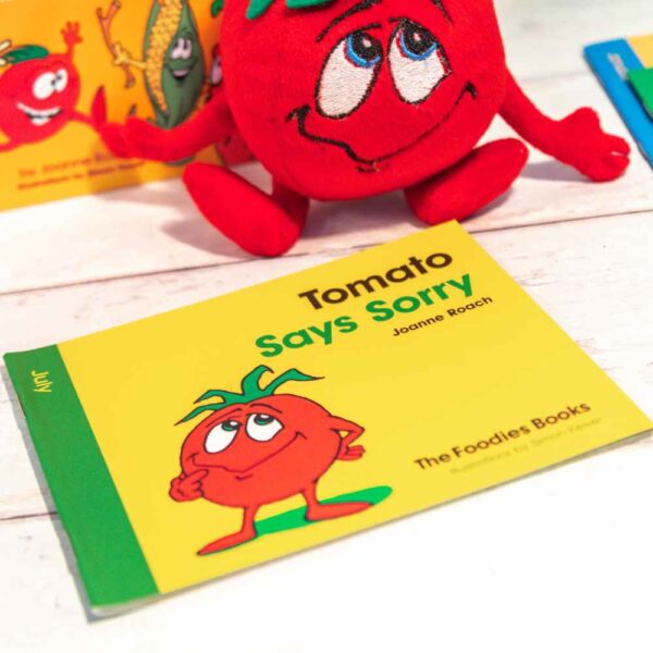 A flatlay image of the book Tomato Says Sorry – The Foodies veggie patch story for July, on a worktop background.